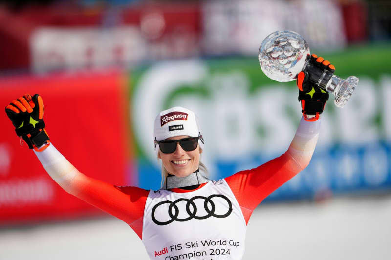 Switzerland's Lara Gut Behrami celebrates with the overall trophy after the Women's Giant Slalom event of FIS Ski Alpine World Cup in Saalbach. Georg Hochmuth/APA/dpa