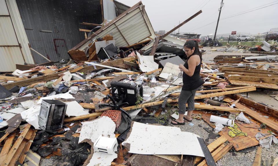 <p>Jennifer Bryant looks over the debris from her family business destroyed by Hurricane Harvey Saturday, Aug. 26, 2017, in Katy, Texas. (Photo: David J. Phillip/AP) </p>