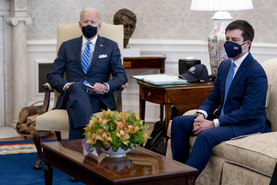 FILE - In this March 4, 2021, file photo, President Joe Biden and Transportation Secretary Pete Buttigieg, right, meet with Vice President Kamala Harris and members of the House of Representatives in the Oval Office of the White House in Washington, on infrastructure. Buttigieg says America's infrastructure needs exceed $1 trillion and that other countries like China are pulling ahead. It's a disparity that Buttigieg is calling “a threat to our collective future” in prepared remarks to Congress. (AP Photo/Andrew Harnik, File)