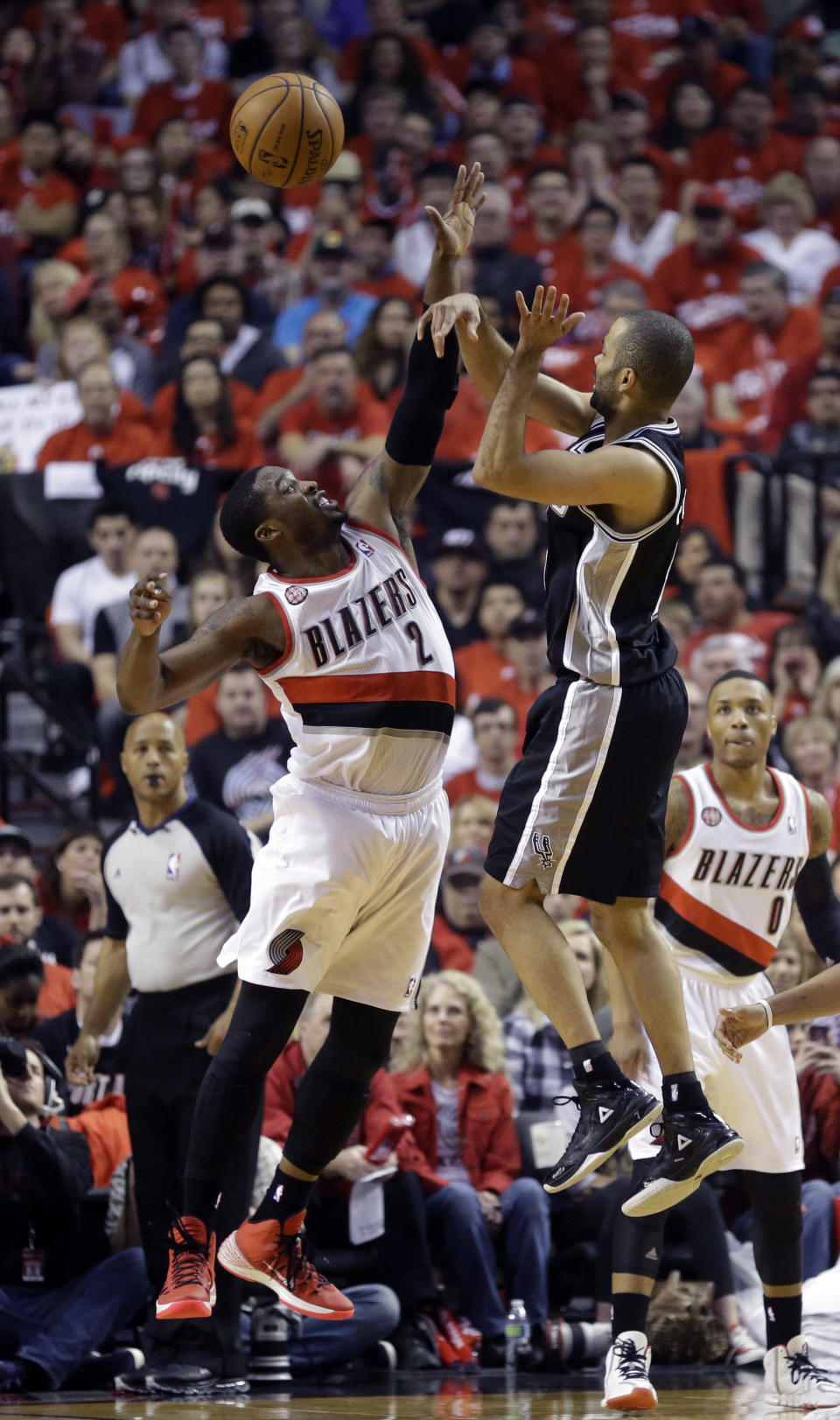 Portland Trail Blazers' Wesley Matthews (2) defends against San Antonio Spurs' Tony Parker (9) as he passes the ball in the first quarter of Game 3 of a Western Conference semifinal NBA basketball playoff series Saturday, May 10, 2014, in Portland, Ore. (AP Photo/Rick Bowmer)