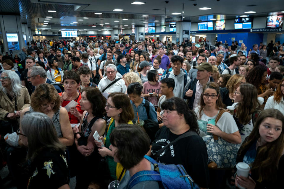 Passengers line up to board a delayed Amtrak train at New York Penn Station, June 19, 2019 in New York City.<span class="copyright">Drew Angerer—Getty Images</span>