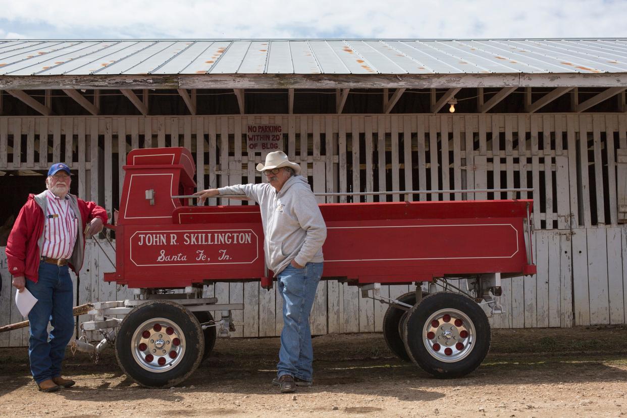 Mule Day organizers Dave Skillington, left, and Rickey Skillington, right, pose with the wagon build by their relative John Robert Skillington inside the Maury County Park on Sunday, April 8, 2018. The wagon which was renovated by Rickey Skillingotn will be used to haul the Mule Day grand marshal in the Mule Day parade.