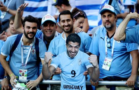 Soccer Football - World Cup - Group A - Uruguay vs Saudi Arabia - Rostov Arena, Rostov-on-Don, Russia - June 20, 2018 Uruguay fans with a cut out of Luis Suarez before the match REUTERS/Marko Djurica