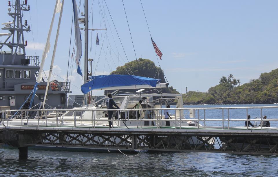 The yacht "Simplicity", that officials say was hijacked by three escaped prisoners with two people aboard, is docked at the St. Vincent and the Grenadines Coastguard Service Calliaqua Base, in Calliaqua, St. Vincent, Friday, Feb. 23, 2024. Authorities in the eastern Caribbean said they were trying to locate two people believed to be U.S. citizens who were aboard the yacht that was hijacked by the three escaped prisoners from Grenada. (AP Photo/Kenton X. Chance)