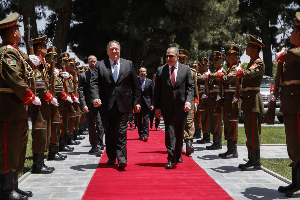 Secretary of State Mike Pompeo, center left, walks with Afghan President Ashraf Ghani's Chief of Staff Abdul Salam Rahimi, as he arrives at the Presidential Palace in Kabul, Afghanistan, Tuesday, June 25, 2019, during an unannounced visit. (AP Photo/Jacquelyn Martin, Pool)