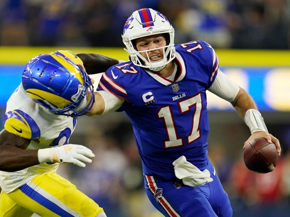 Josh Allen delivers a stiff arm to Rams safety Nick Scott.