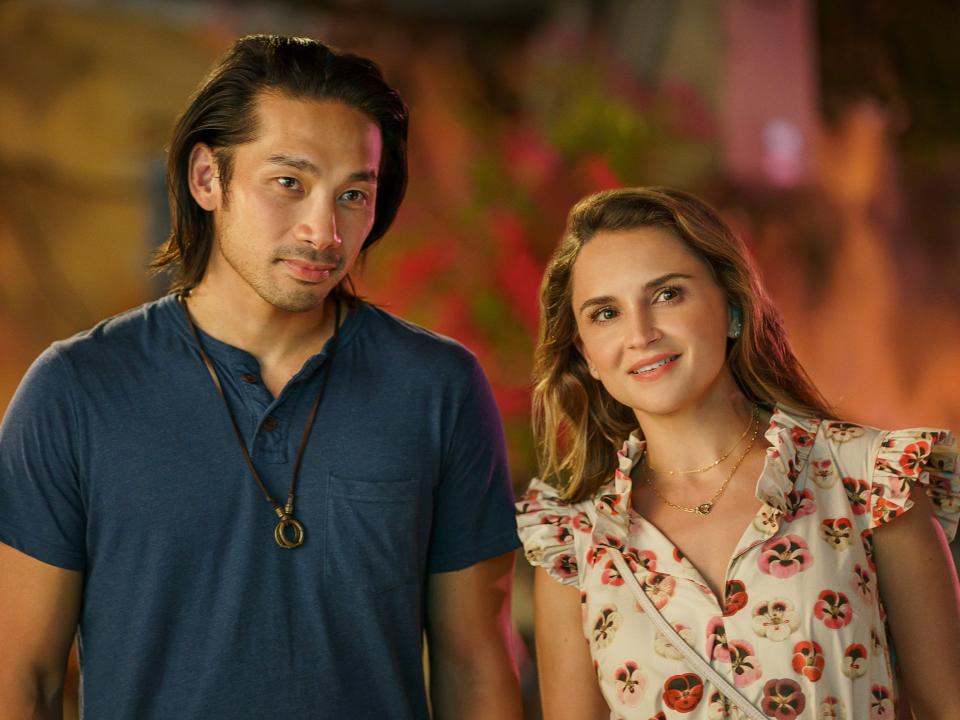 Scott Ly and Rachael Leigh Cook standing next to each other in a scene from A Tourist's Guide to Love