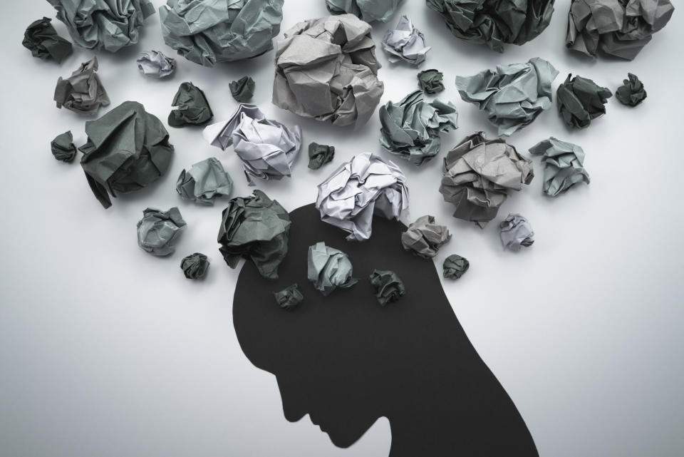 Concept image of anxiety and negative emotion. Waste paper and head silhouette. (Getty Images)