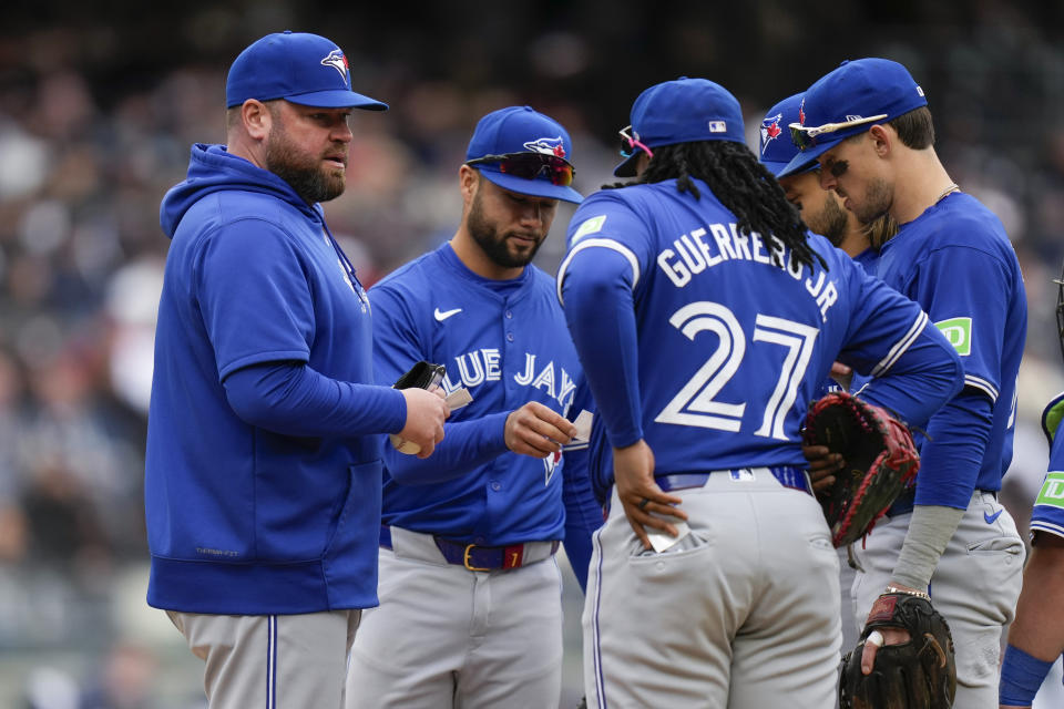 Toronto Blue Jays manager John Schneider, left, talks with players on the mound during the sixth inning of the baseball game against the New York Yankees at Yankee Stadium Friday, April 5, 2024, in New York. (AP Photo/Seth Wenig)
