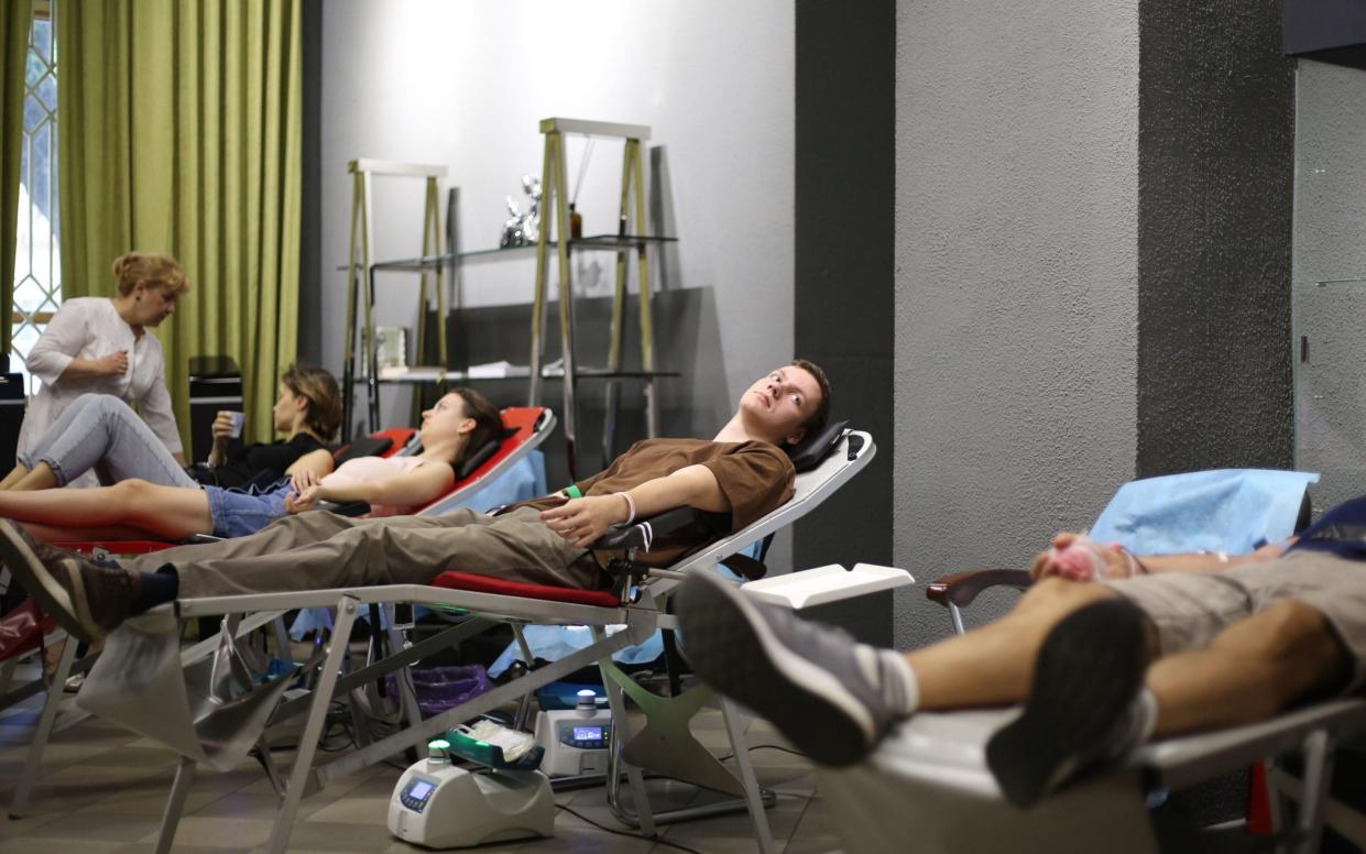 Donors give blood at the Union Cultural Center in Odessa, Ukraine