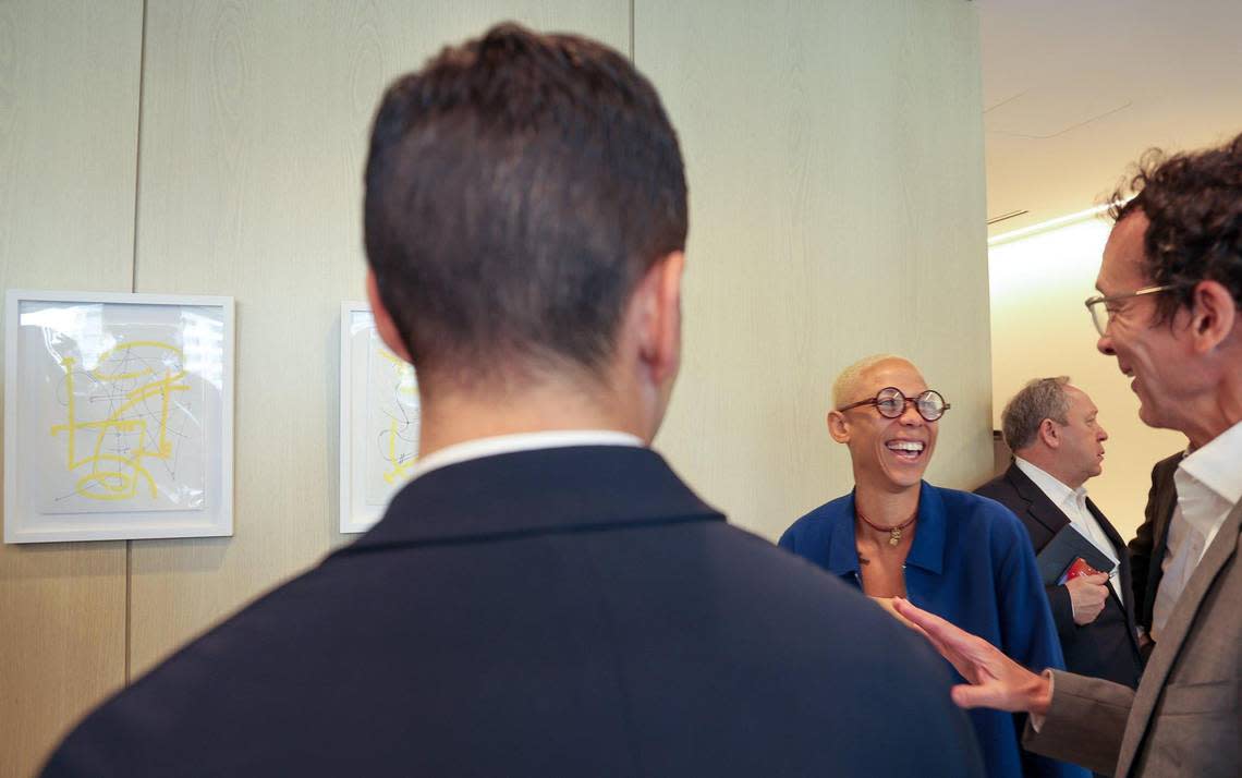 Artist Najja Moon, center, chats with visitors as they toured the new European bank BNP Paribas office after announcing the opening of its Brickell office on Wednesday, December 6, 2023 at Miami’s Brickell financial district in Miami, Florida.