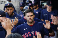 Boston Red Sox' J.D. Martinez celebrates in the dugout after scoring on a Hunter Renfroe base hit during the first inning of the team's baseball game against the Atlanta Braves on Wednesday, June 16, 2021, in Atlanta. (AP Photo/John Bazemore)