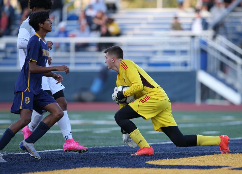 Marlboro keeper Alex McAteer (right) vs. Lourdes.