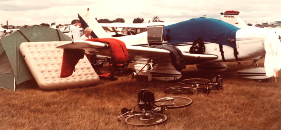 Edna Meserve stands behind the wing of the Piper Archer plane her husband, Al, flew to take them on hiking and biking trips. Here they had unloaded the tent, air mattress, camping gear and bicycles packed in the plane when they flew to an air show in Oshkosh, Wisconsin.