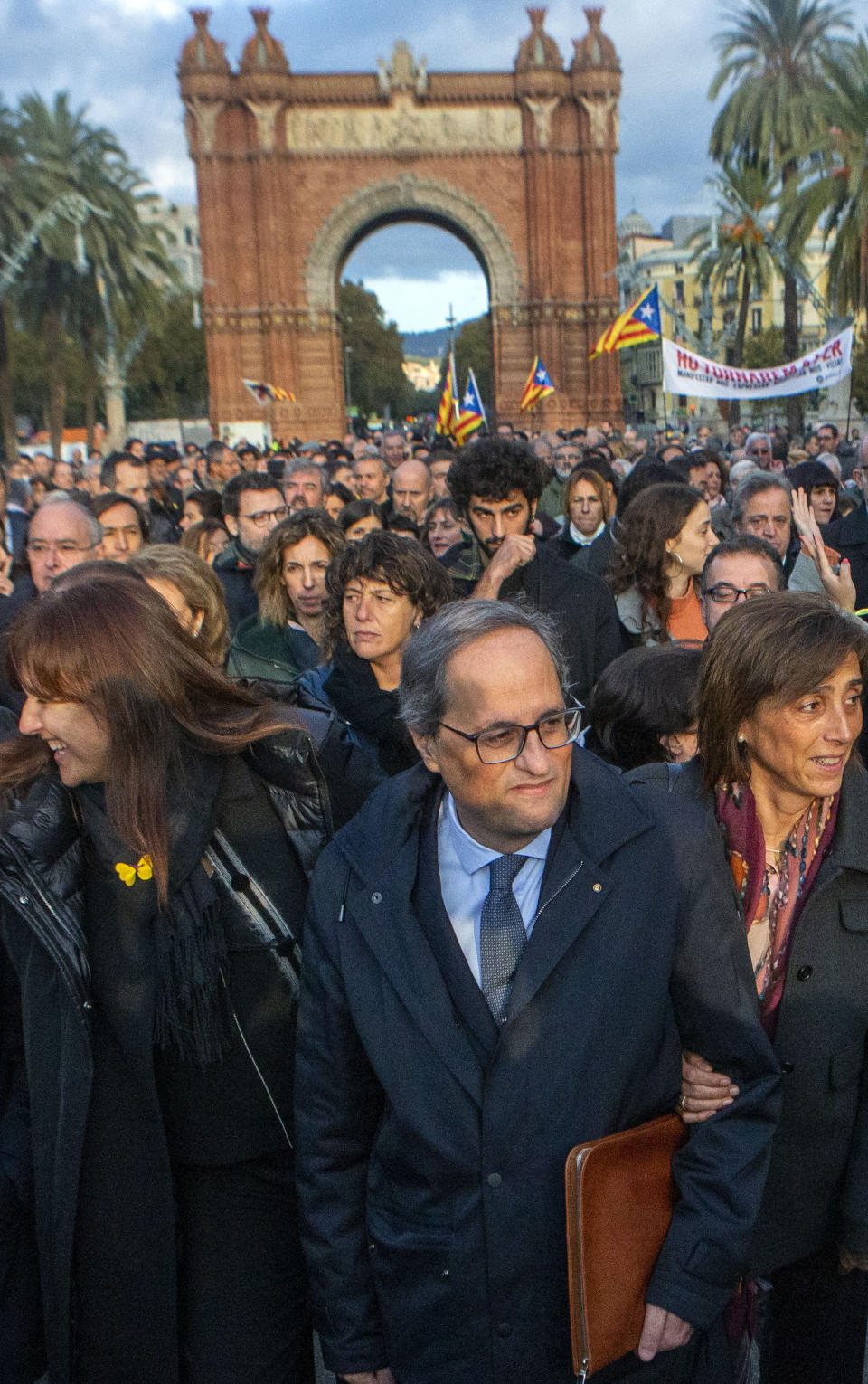 Catalan regional president Quim Torra, centre, walks to the Catalonia's high court in Barcelona, Spain, Monday, Nov.18, 2019. The pro-independence regional president of Catalonia is standing trial for allegedly disobeying Spain's electoral board by not removing pro-secession symbols from public buildings during an election campaign. (AP Photo/Joan Mateu)