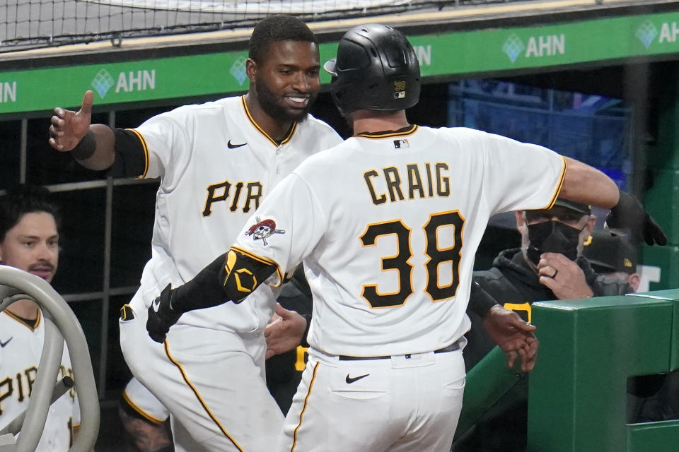 Pittsburgh Pirates' Will Craig (38) is greeted at the dugout steps by Gregory Polanco after getting his first major league hit, a solo home run, off San Francisco Giants relief pitcher Camilo Doval during the eighth inning of a baseball game in Pittsburgh, Thursday, May 13, 2021.(AP Photo/Gene J. Puskar)