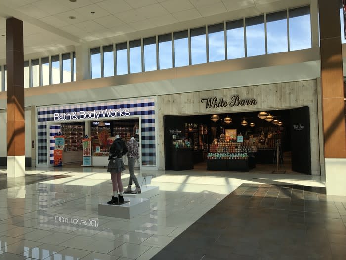 An exterior view of Bath & Body Works and White Barn Candle stores.