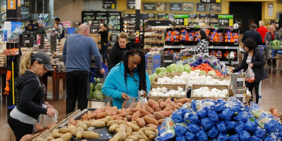 FILE - In this Nov. 27, 2019, file photo people shop for food the day before the Thanksgiving holiday at a Walmart Supercenter in Las Vegas.  U.S. consumer prices increased slightly last month, driven higher by more expensive food. The Labor Department said Wednesday, March 11, 2020, that the consumer price index ticked up 0.1% last month, matching its January increase.  (AP Photo/John Locher, File)