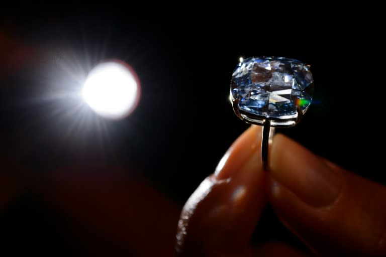 Hong Kong property tycoon Joseph Lau has snapped up the 12.03-carat blue diamond dubbed "Blue Moon" for a record $48.4 million at Sotheby's in Geneva