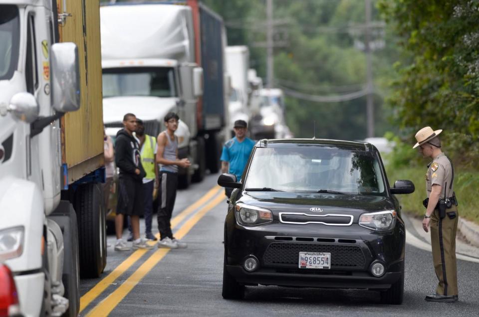 A Maryland State Police officer speaks with a motorist near the scene of the shooting