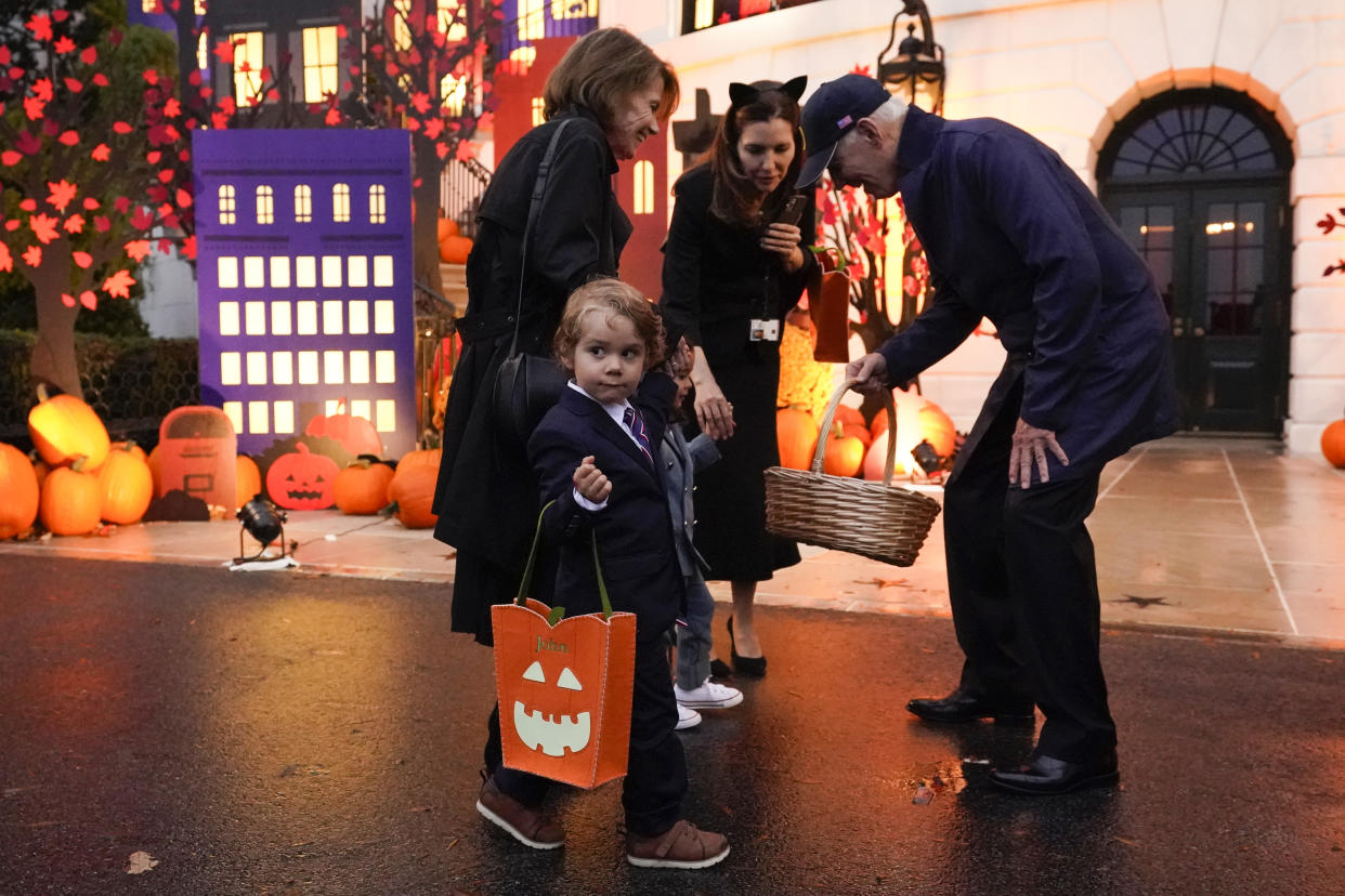 President Joe Biden greets members of Secretary of State Antony Blinken's family as he and first lady Jill Biden give treats to trick-or-treaters on the South Lawn of the White House, on Halloween, Monday, Oct. 31, 2022, in Washington. (AP Photo/Alex Brandon)