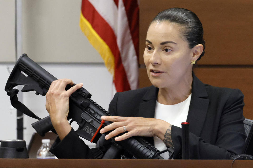 Broward Sheriff's Office Sgt. Gloria Crespo testifies about the weapon used by Marjory Stoneman Douglas High School shooter Nikolas Cruz in the 2018 shootings. This during the penalty phase of Cruz's trial at the Broward County Courthouse in Fort Lauderdale, Fla. on Tuesday, Sept. 27, 2022. Sgt. Crespo took the photograph (for evidence purposes) of the gun used by Cruz after the shootings. Cruz previously plead guilty to all 17 counts of premeditated murder and 17 counts of attempted murder in the 2018 shootings. (Amy Beth Bennett/South Florida Sun Sentinel via AP, Pool)