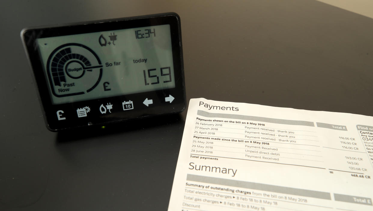 A smart meter next to an energy bill.