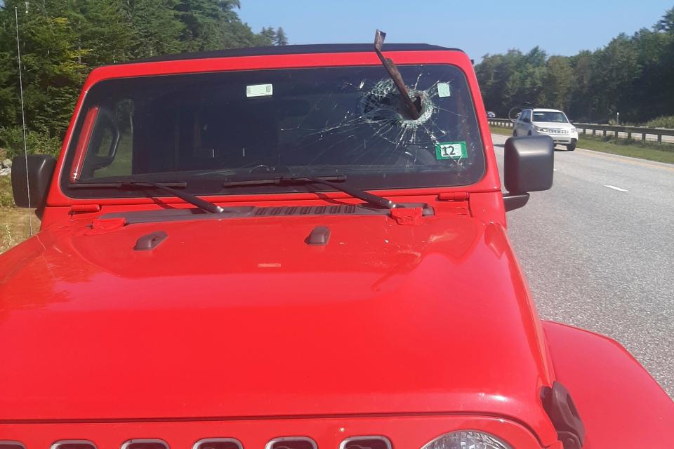 This photo provided by the Maine State Police shows a Jeep that was struck by a piece of metal that came within inches of a motorist's face, on the Maine Turnpike, in Gray, Maine, on Tuesday, Sept. 5, 2023. Police said the 21-year-old motorist from New Hampshire was following a vehicle that ran over the metal road debris, sending it flying into the windshield of her Jeep Wrangler.