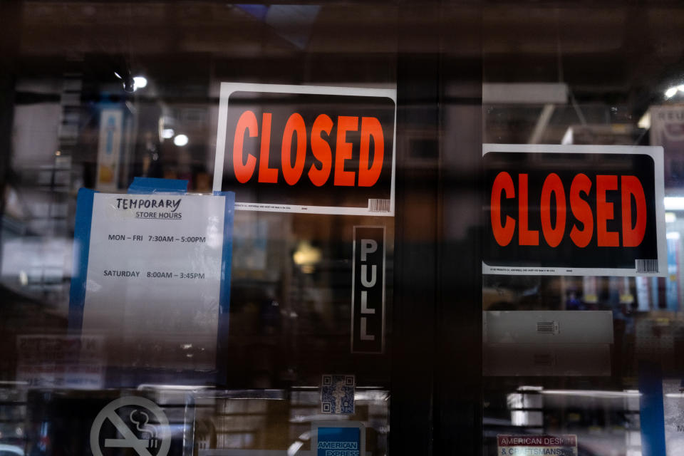 Temporary closed signage is seen at a store in Manhattan borough following the outbreak of coronavirus disease (COVID-19), in New York City, U.S., March 15, 2020. REUTERS/Jeenah Moon - RC2JKF90MMG7