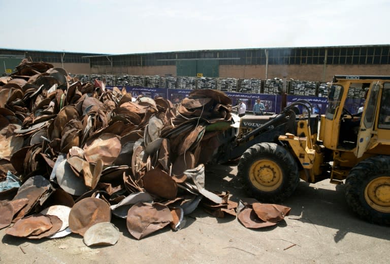 Satellite dishes and receivers being piled up before being destroyed during a ceremony in the Iranian capital Tehran on July 24, 2016