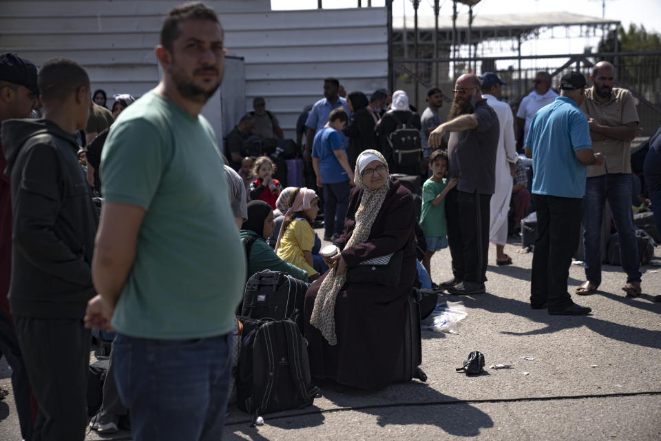 Palestinians wait to cross into Egypt at the Rafah border crossing in the Gaza Strip on Monday, Oct.16, 2023. (AP Photo/Fatima Shbair)