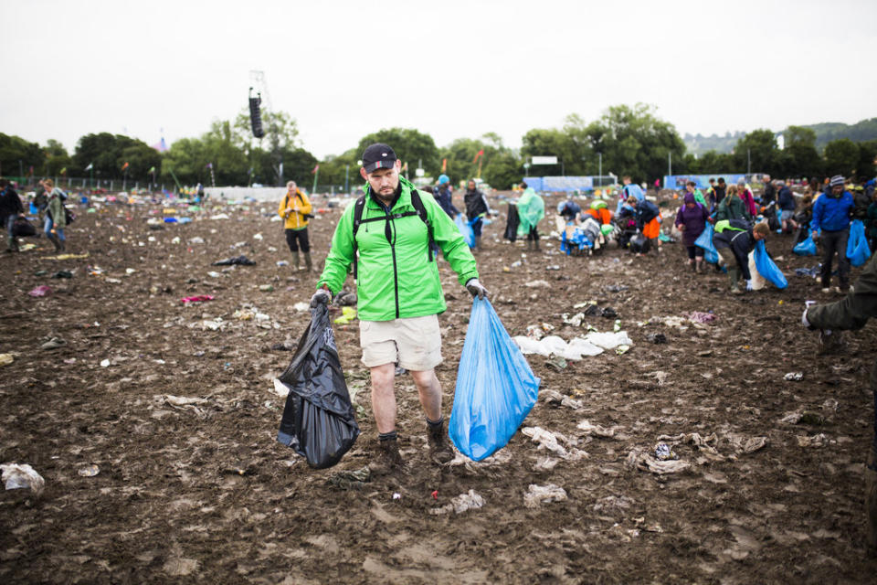  A fan makes the long trek out of Glastonbury.