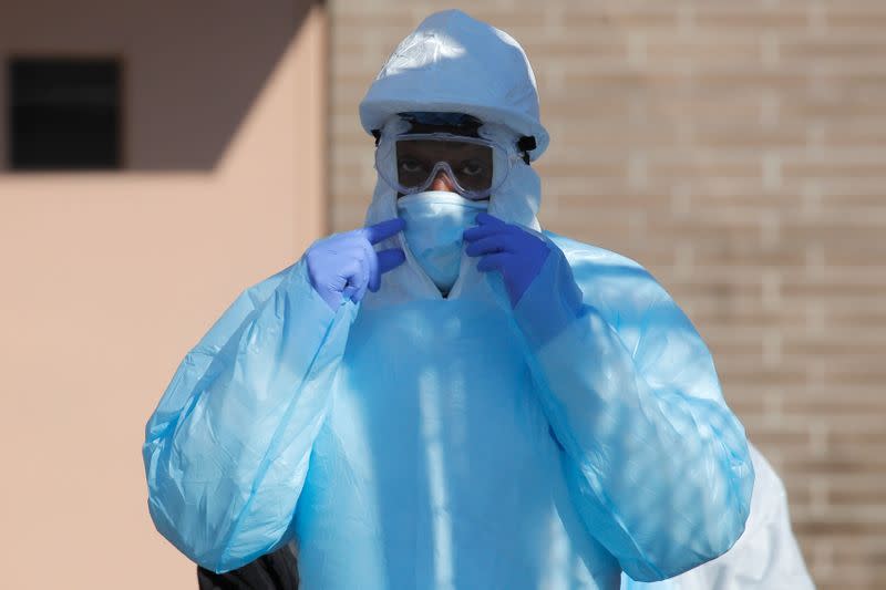 Healthcare workers in PPE outside Wyckoff Heights Medical Center during outbreak of coronavirus disease (COVID-19) in New York