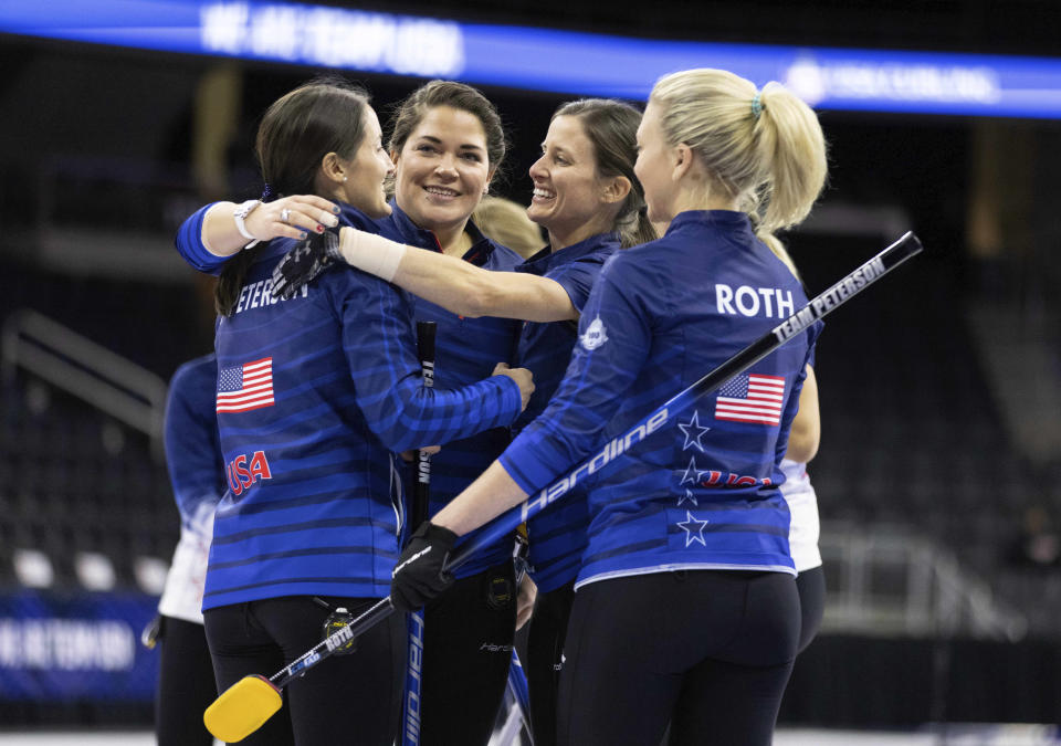 FILE - Team Peterson, from left, Tabitha Peterson, Becca Hamilton, Tara Peterson and Nina Roth celebrate a victory over Team Christensen at the U.S. Olympic curling team trials at Baxter Arena in Omaha, Neb., Friday, Nov. 19, 2021. Tabitha Peterson is heading to her second straight Olympics — her first as the skip of the U.S. women’s team. Roth is back at vice-skip, throwing third, with fellow 2018 holdover Becca Hamilton second. Olympic rookie Tara Peterson, Tabitha’s sister, is the lead, throwing first. (AP Photo/Rebecca S. Gratz, File)