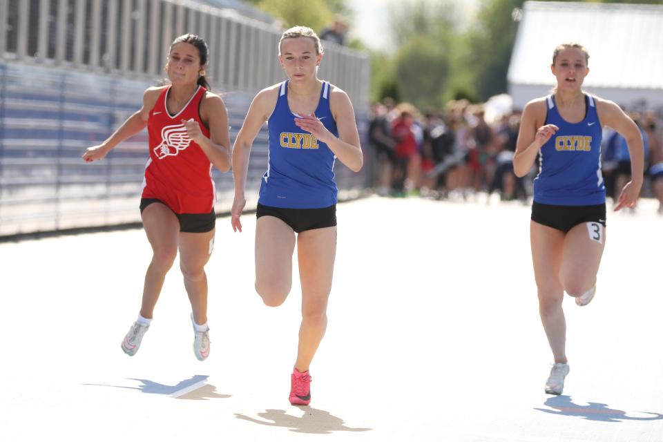 Clyde's Bree Caudill, center, leads teammate Gabby Griffin and Bellevue's Amerie Wagner in the 100 meter dash.