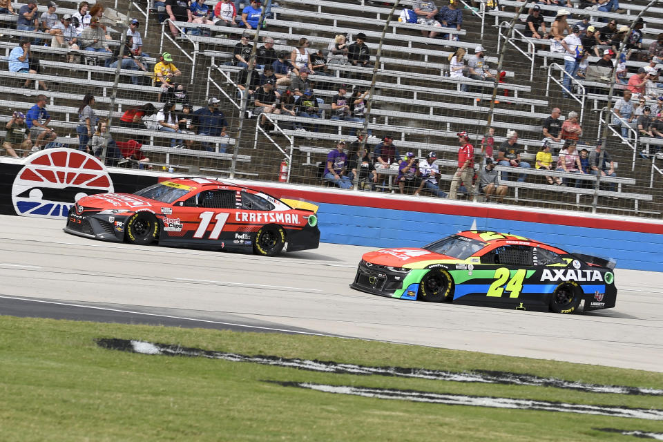 Denny Hamlin (11) and William Byron (24) drive during a NASCAR Cup Series auto race at Texas Motor Speedway Sunday, Oct. 17, 2021, in Fort Worth, Texas. (AP Photo/Randy Holt)