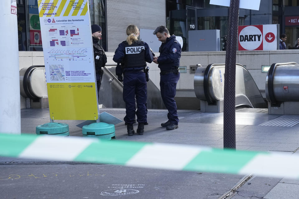 Police officers stand by a subway station after a woman allegedly made threatening remarks on a train, Tuesday, Oct. 31, 2023 in Paris. Paris police opened fire on a woman who allegedly made threatening remarks on a train, the latest security incident in the country that has been on heightened anti-terror alert since a fatal stabbing at a school blamed on an Islamic extremist. (AP Photo/Michel Euler)