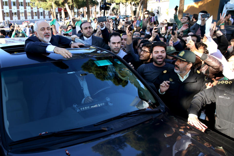 Iranian Foreign Minister Mohammad Javad Zarif, who is also Iran's top nuclear negotiator, waves to his well wishers upon arrival at the Mehrabad airport in Tehran, Iran, from Lausanne, Switzerland, Friday, April 3, 2015. (AP Photo/Ebrahim Noroozi)