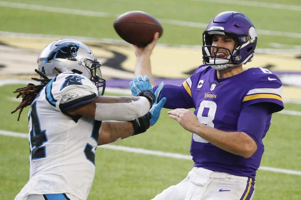 Minnesota Vikings quarterback Kirk Cousins (8) is pressured by Carolina Panthers linebacker Shaq Thompson during the second half of an NFL football game, Sunday, Nov. 29, 2020, in Minneapolis. (AP Photo/Bruce Kluckhohn)