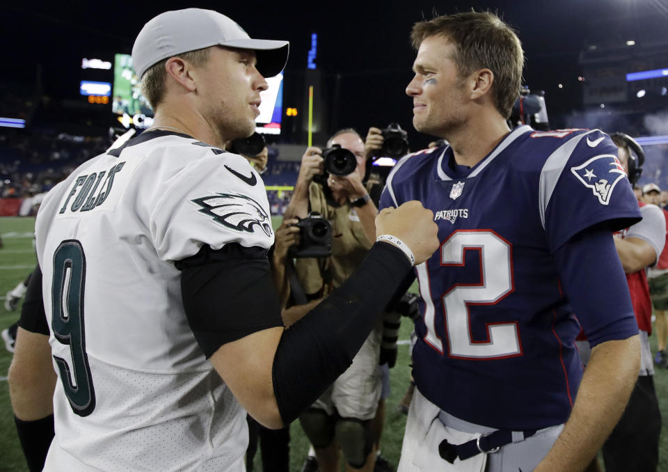 Philadelphia Eagles quarterback Nick Foles (9) and New England Patriots quarterback Tom Brady (12) speak at midfield after a preseason NFL football game, Thursday, Aug. 16, 2018, in Foxborough, Mass. (AP Photo/Charles Krupa)