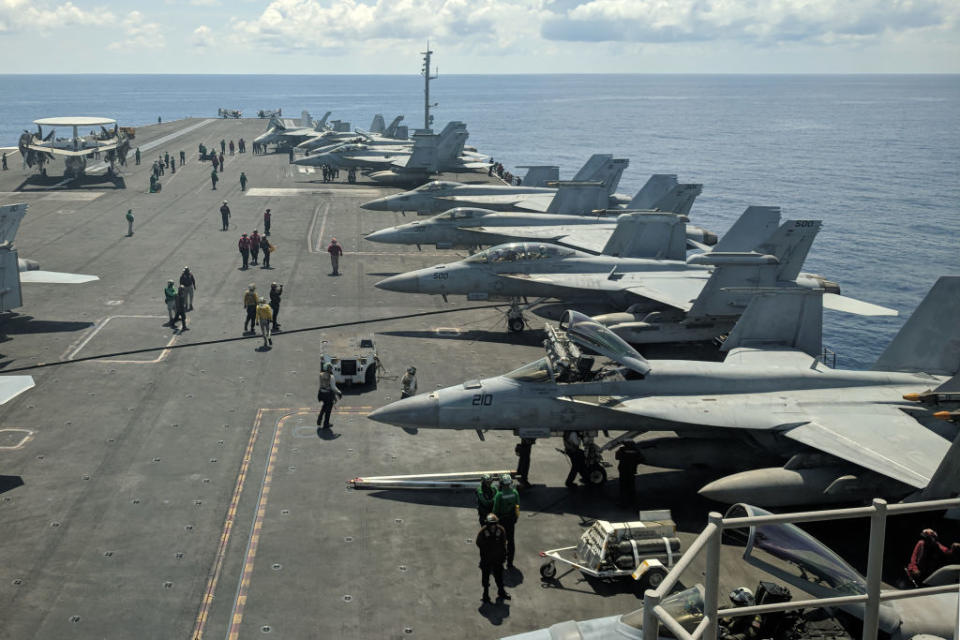 US Navy F/A-18 Super Hornets multirole fighters and an EA-18G Growler electronic warfare aircraft (2nd R) on board USS Ronald Reagan aircraft carrier as it sails in South China Sea. Source: Getty