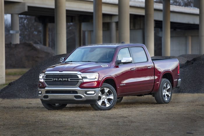 A red Ram 1500, with a highway overpass in the background.