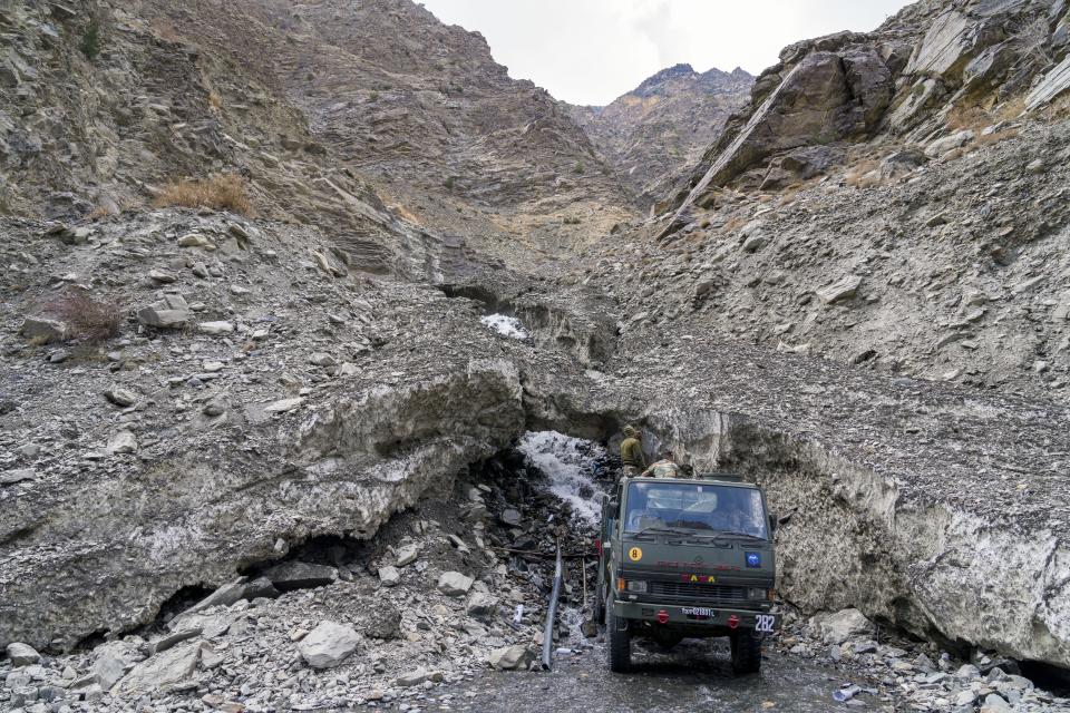 Indian army personnel collect water from a melting glacier in the Kinnaur district of the Himalayan state of Himachal Pradesh, India, Tuesday, March 14, 2023. (AP Photo/Ashwini Bhatia)