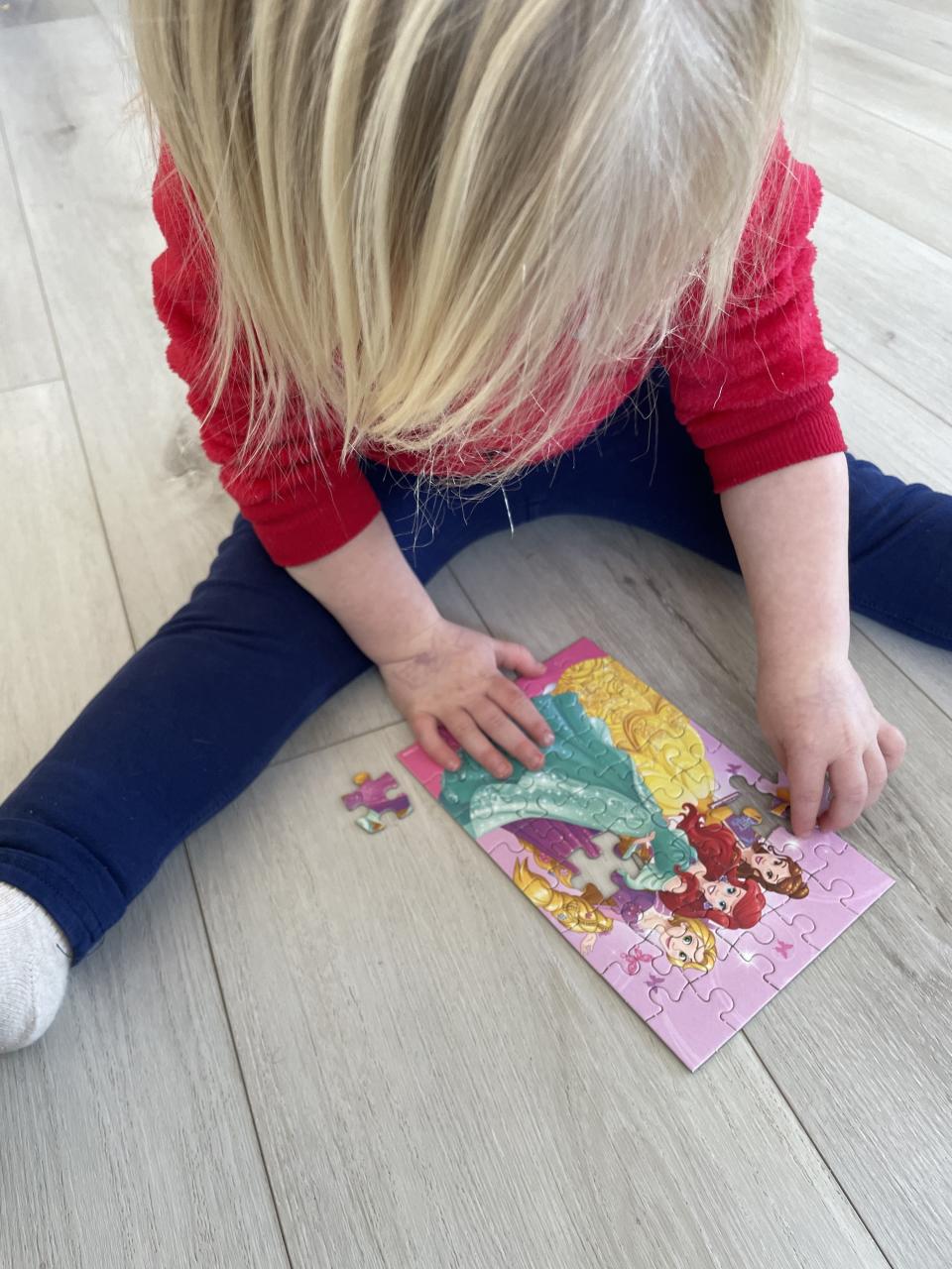 the author's daughter putting together a puzzle