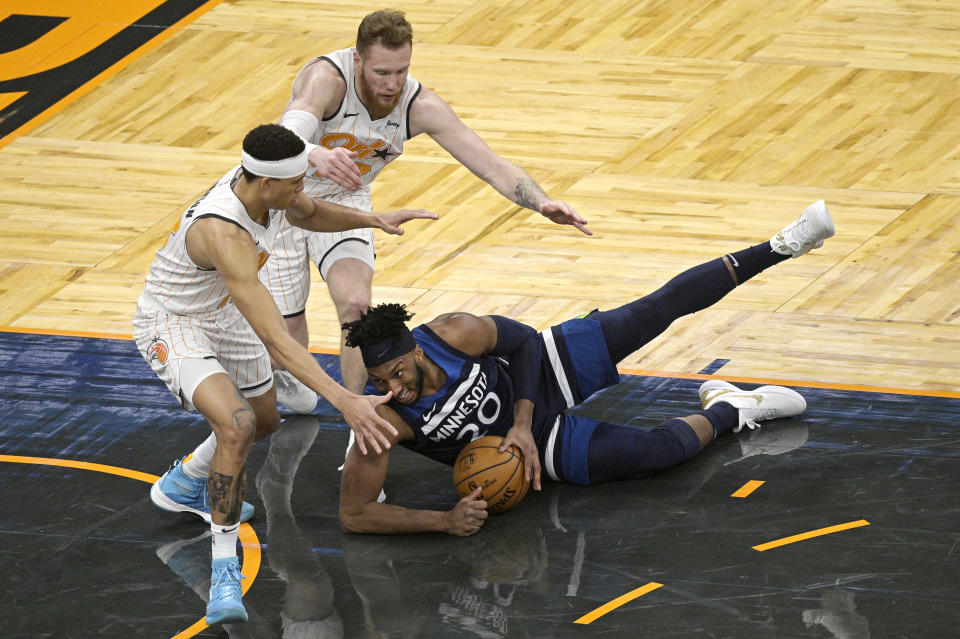 Minnesota Timberwolves forward Josh Okogie (20) gains control of the ball in front of Orlando Magic guard R.J. Hampton, left, and forward Ignas Brazdeikis during the second half of an NBA basketball game Sunday, May 9, 2021, in Orlando, Fla. (AP Photo/Phelan M. Ebenhack)