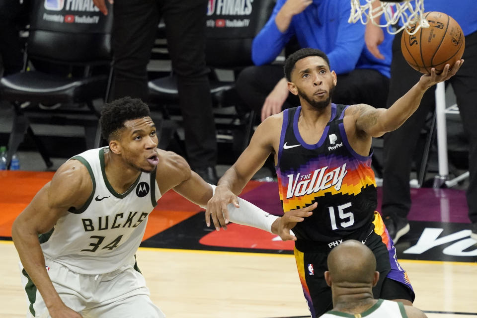 Phoenix Suns guard Cameron Payne (15) shoots against Milwaukee Bucks forward Giannis Antetokounmpo (34) during the first half of Game 5 of basketball's NBA Finals, Saturday, July 17, 2021, in Phoenix. (AP Photo/Matt York)