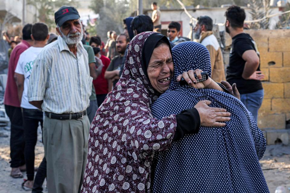 Women console eachother in the aftermath of Israeli bombardment in Rafah (AFP via Getty Images)