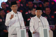 Indonesian President Joko Widodo, left, delivers a speech with running mate Ma'ruf Amin, right, during a televised debate in Jakarta, Indonesia, Thursday, Jan. 17, 2019. Indonesia is gearing up to hold its presidential election on April 17 that will pit in the incumbent against the former general.(AP Photo / Tatan Syuflana)