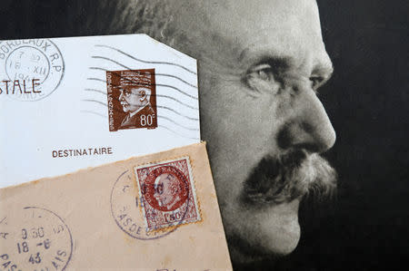 Stamps and a portrait of French General Philippe Petain, published in the French newspaper ''L'Illustration" on May 5, 1917 (R), are seen in this picture illustration taken November 8, 2018. REUTERS/Charles Platiau/Illustration