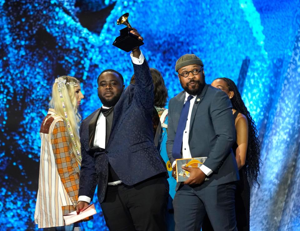 Larry Jenkins Jr., center right, of the Tennessee State University Marching Band accepts the award for best roots gospel album for "The Urban Hymnal" at the 65th annual Grammy Awards on Sunday, Feb. 5, 2023, in Los Angeles. (AP Photo/Chris Pizzello)